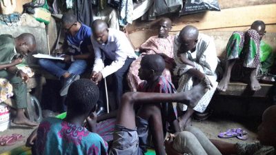 A number of people in a very crowded room where they live in Lagos, Nigeria