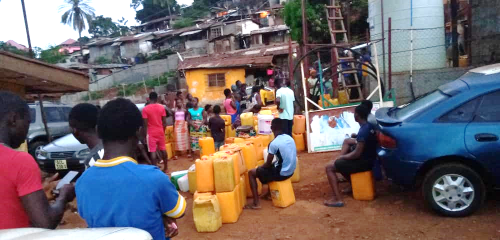Residents of Dwarzark queuing up for water during lockdown