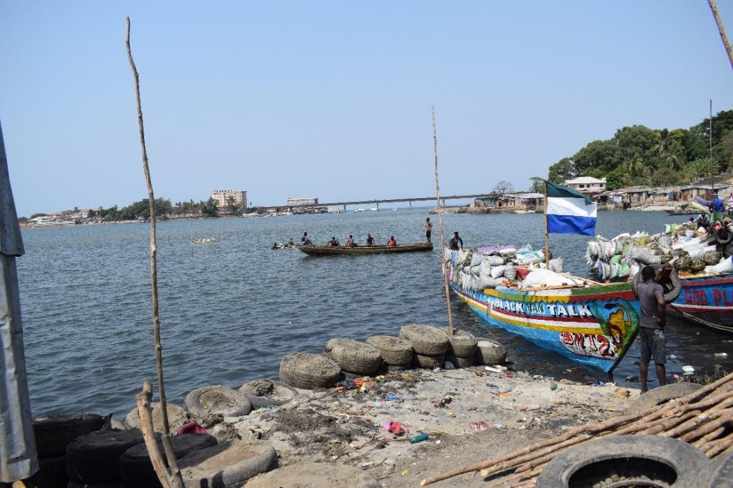 Boat transporting goods to Freetown through Cockle Bay and fish processing 