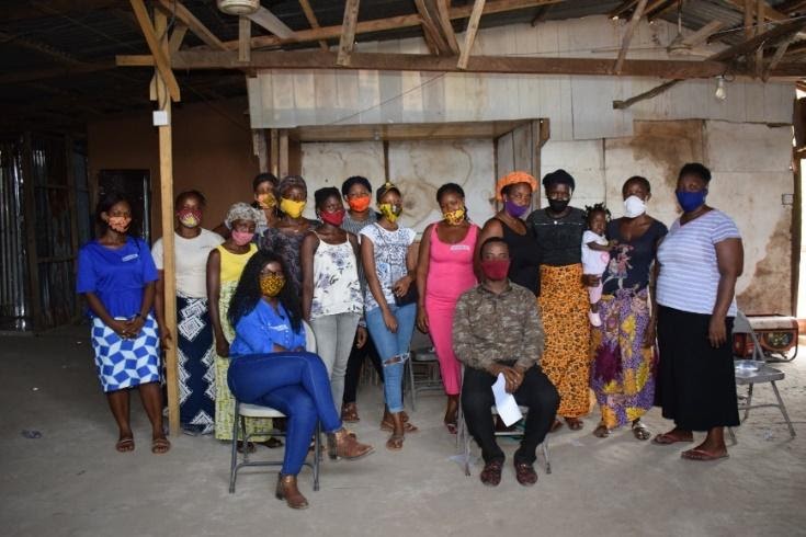 Researchers, co-researchers and a group of community women working together on analysis.3