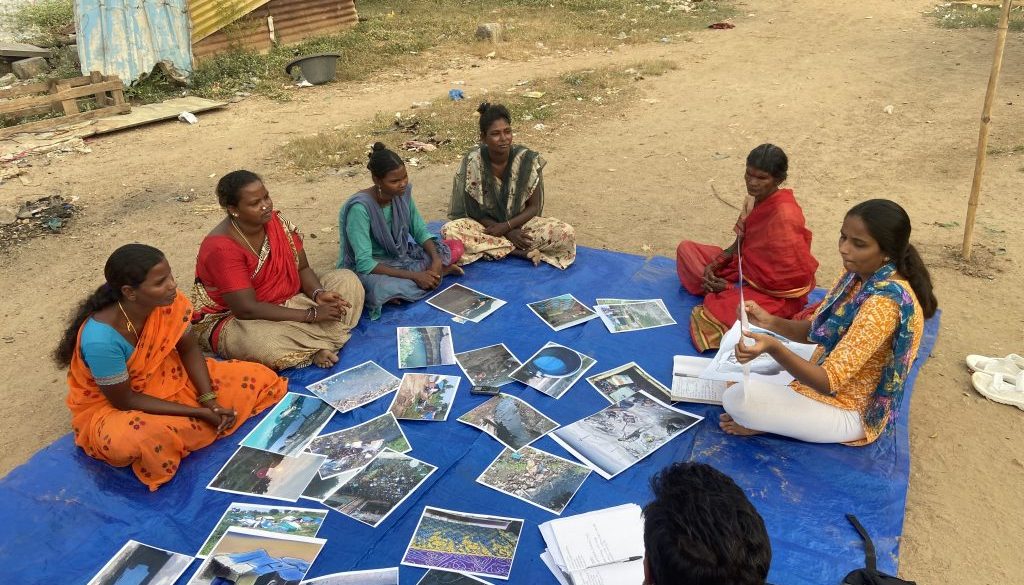 Women in India discussing the photos that they have taken